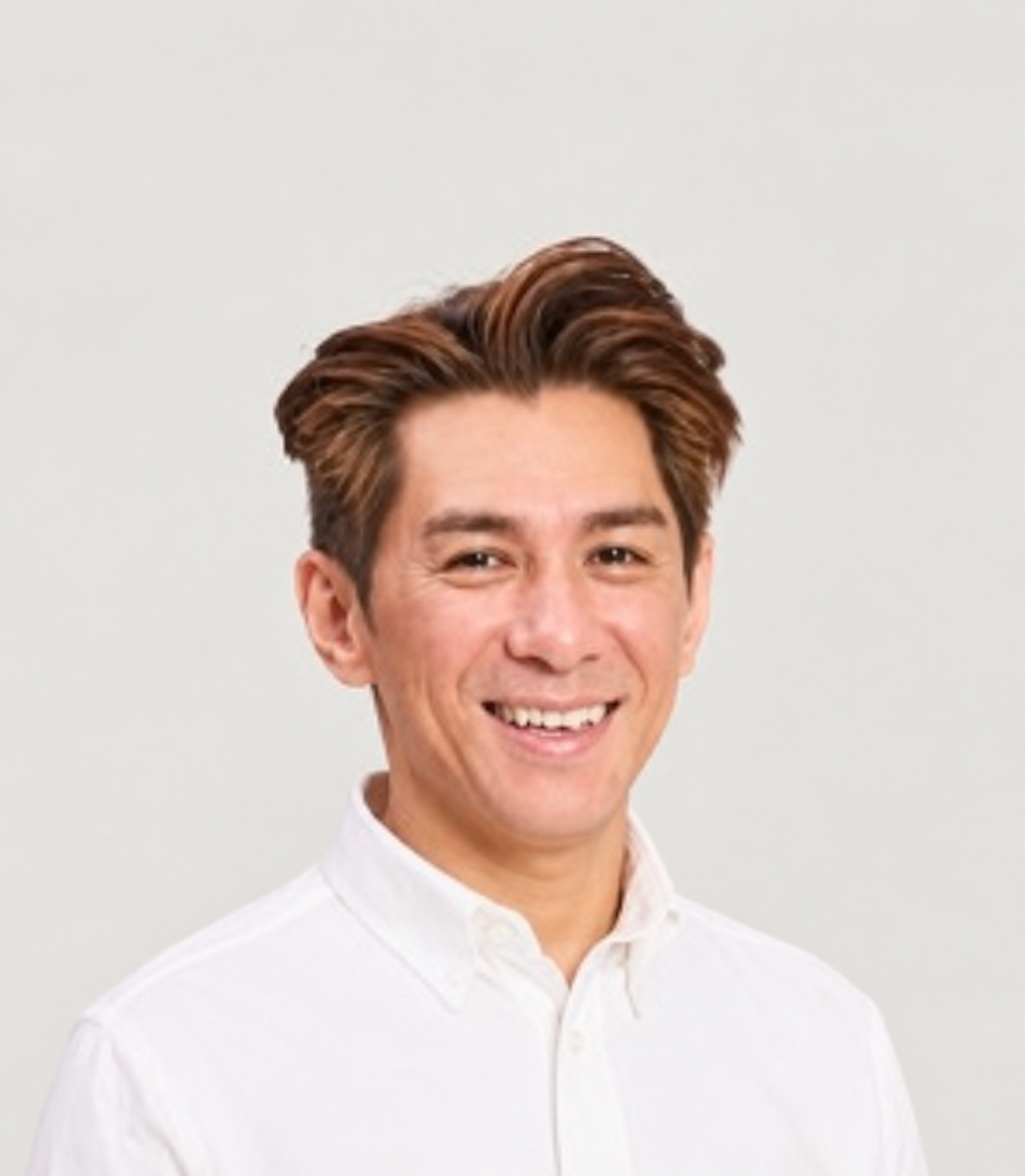 Henry Tang seated in a white shirt and navy trousers